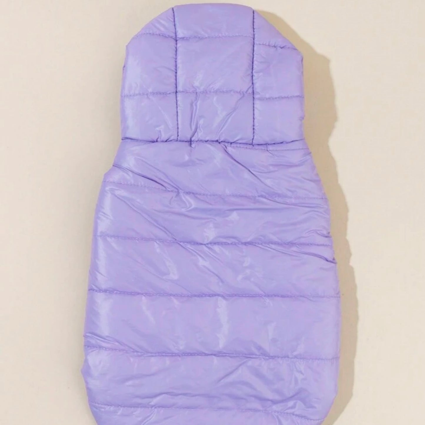 A light purple puffer dog jacket with a hood, laid flat to display the back and stitching details.