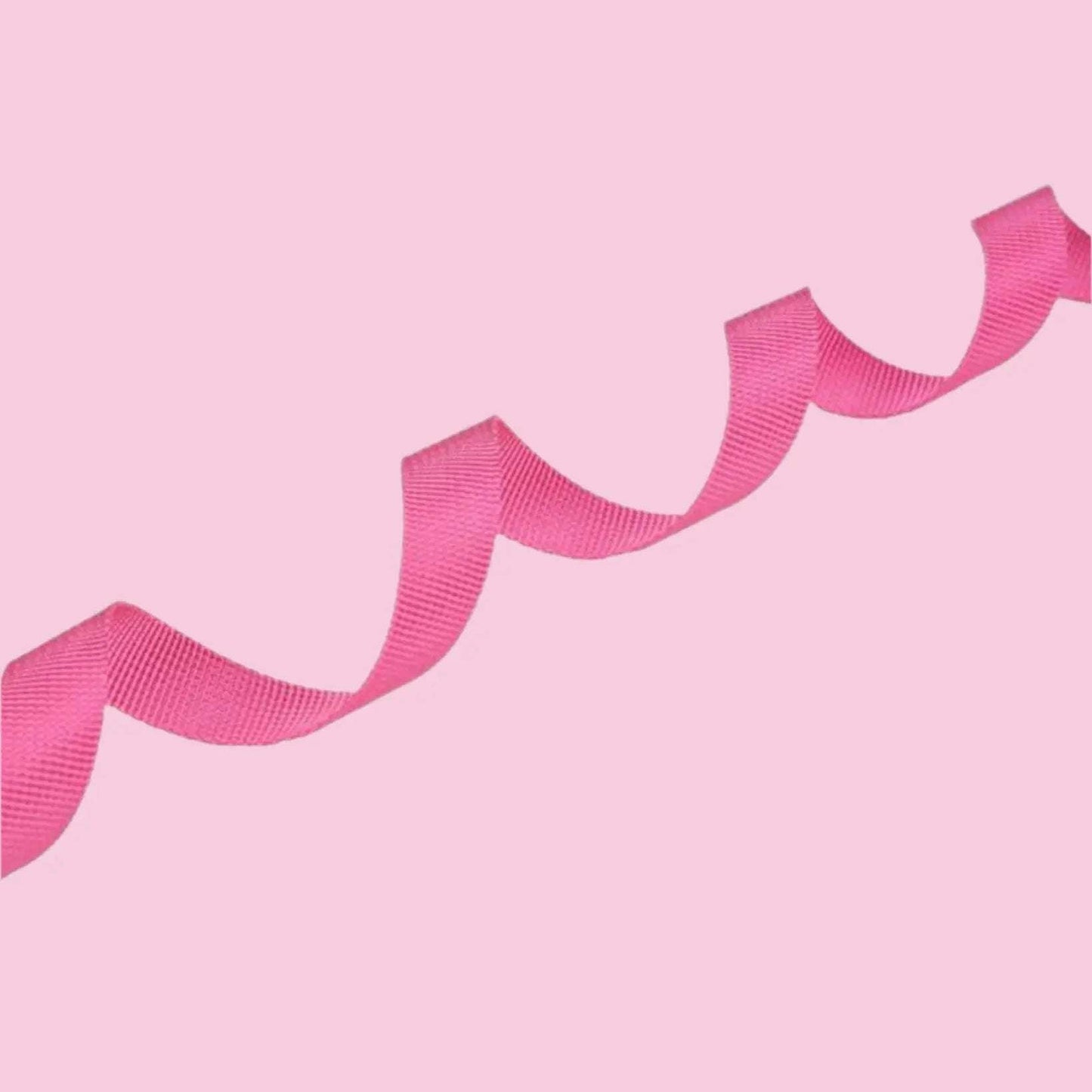 Pink dog lead arranged in a wavy pattern on a pink background.
