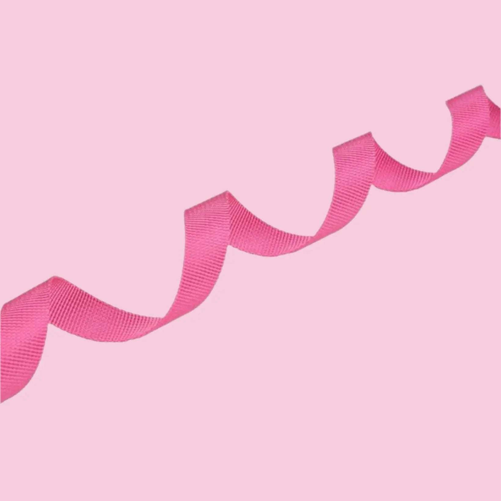 Pink dog lead arranged in a wavy pattern on a pink background.