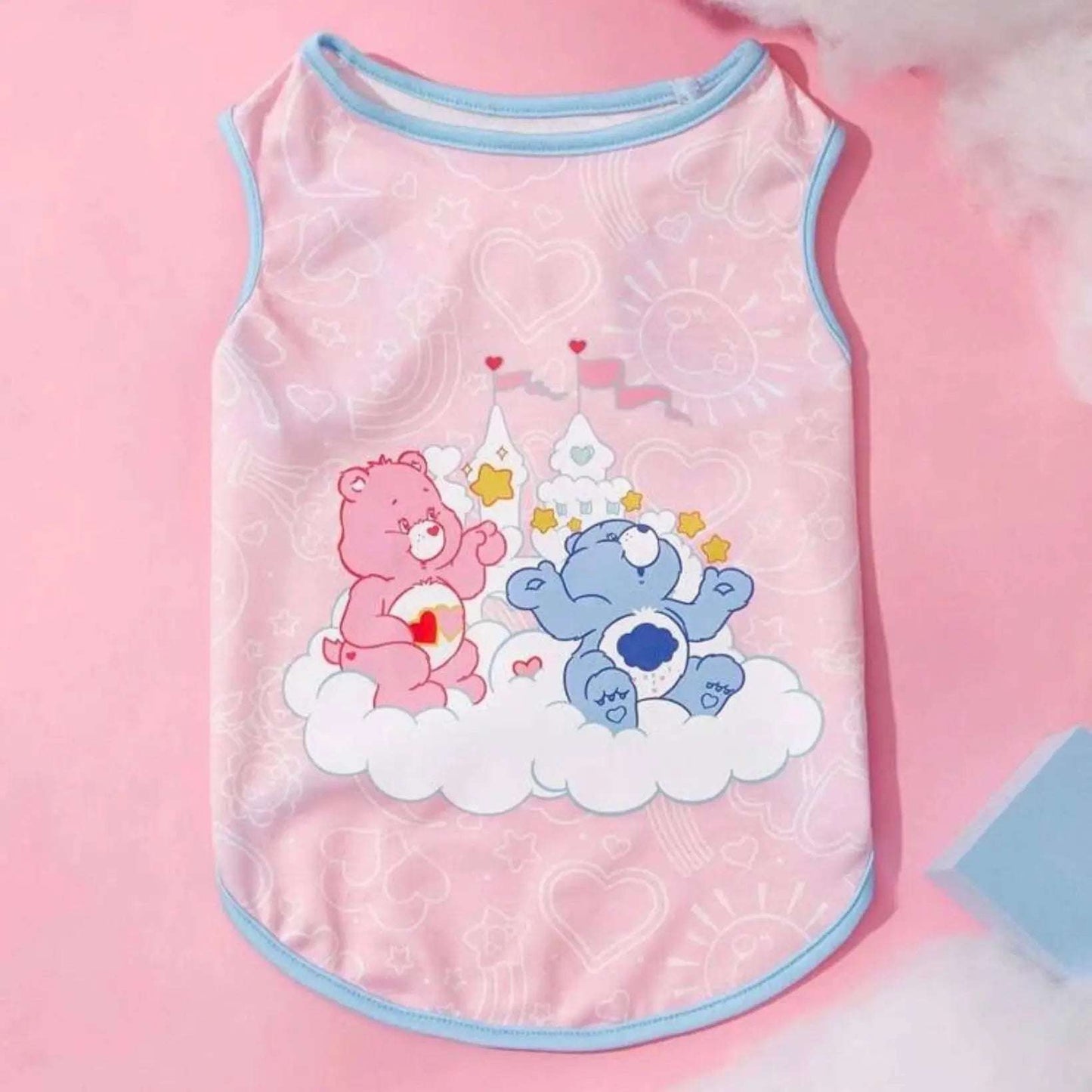 Pink dog tank top with blue trim, front view, displaying Care Bears sitting on a cloud graphic.