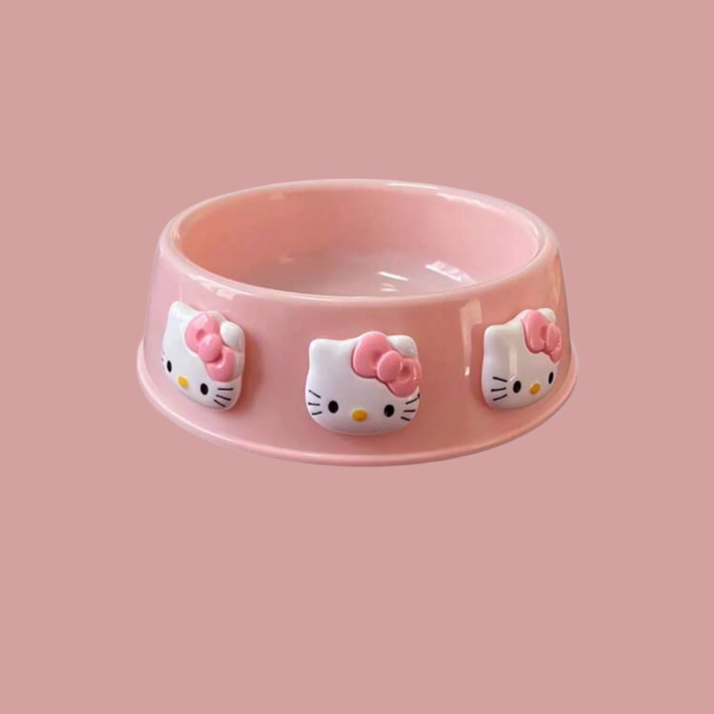 Pastel pink dog bowl decorated with Hello Kitty faces and a pink background.