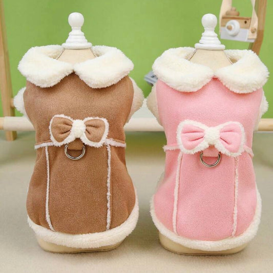 Brown and pink dog jackets with faux shearling trim and bow detail displayed on mannequins.