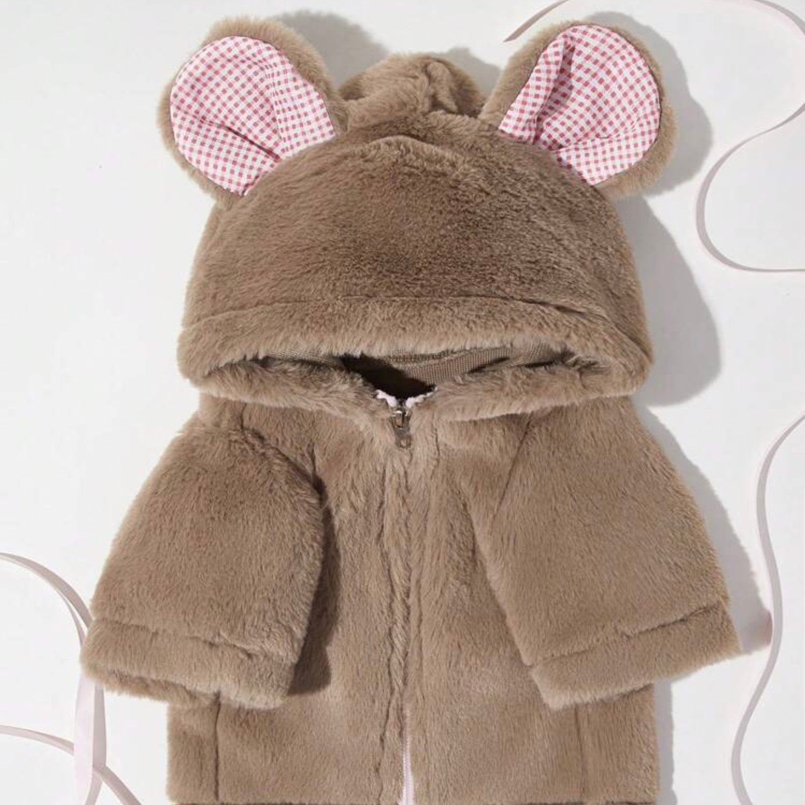 Brown plush dog jacket with a hood featuring bear ears lined in red-and-white check fabric, shown laid flat with the zipper closed.
