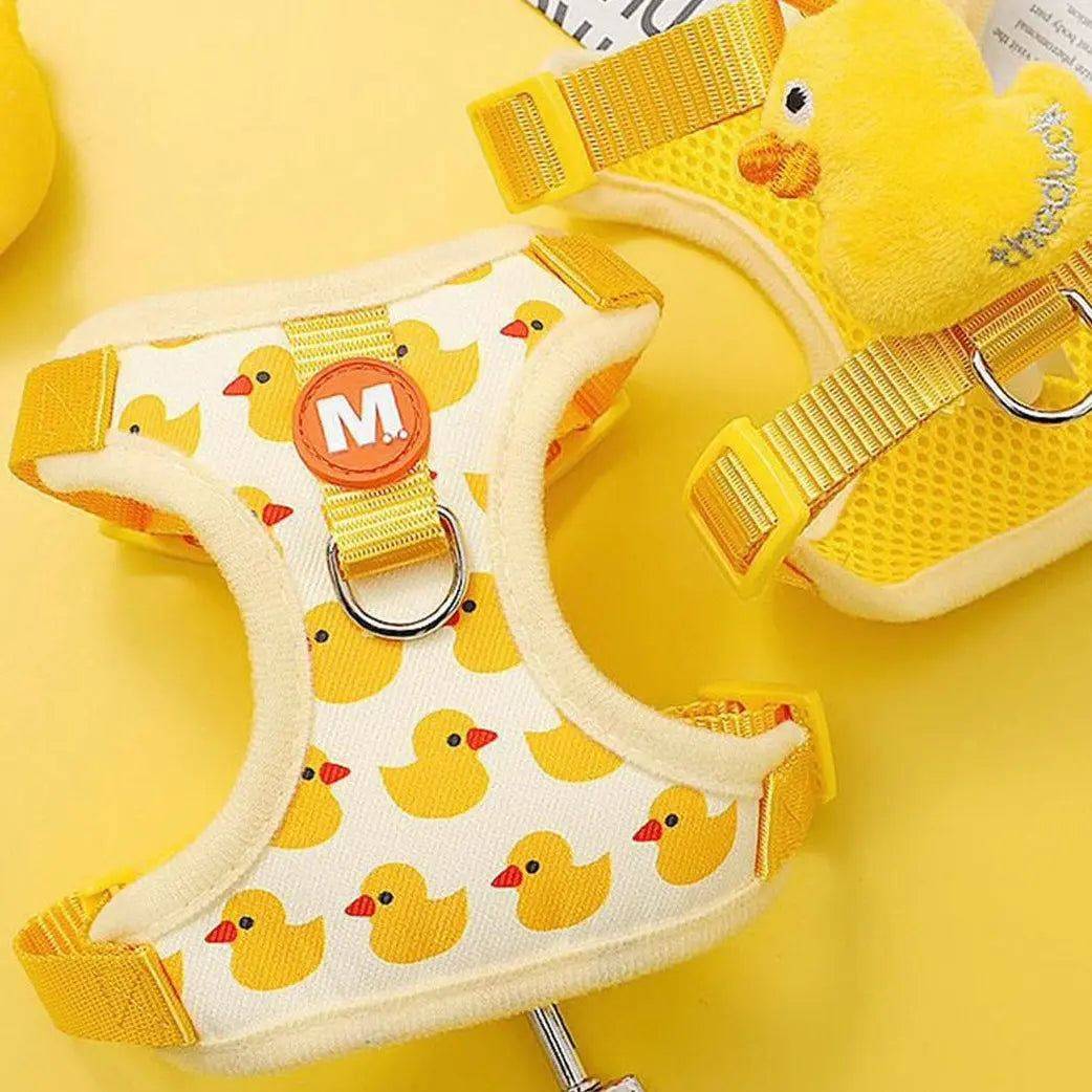 Yellow dog harness with duck pattern, size medium, shown with a yellow plush duck accent on the back of the harness.