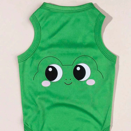 Green dog shirt with a cartoon frog face design laid flat on a surface.
